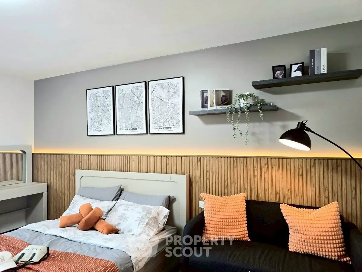 Modern bedroom with stylish decor, featuring cozy bed and elegant wall art.