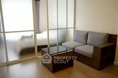 Modern living room with glass partition and cozy seating area