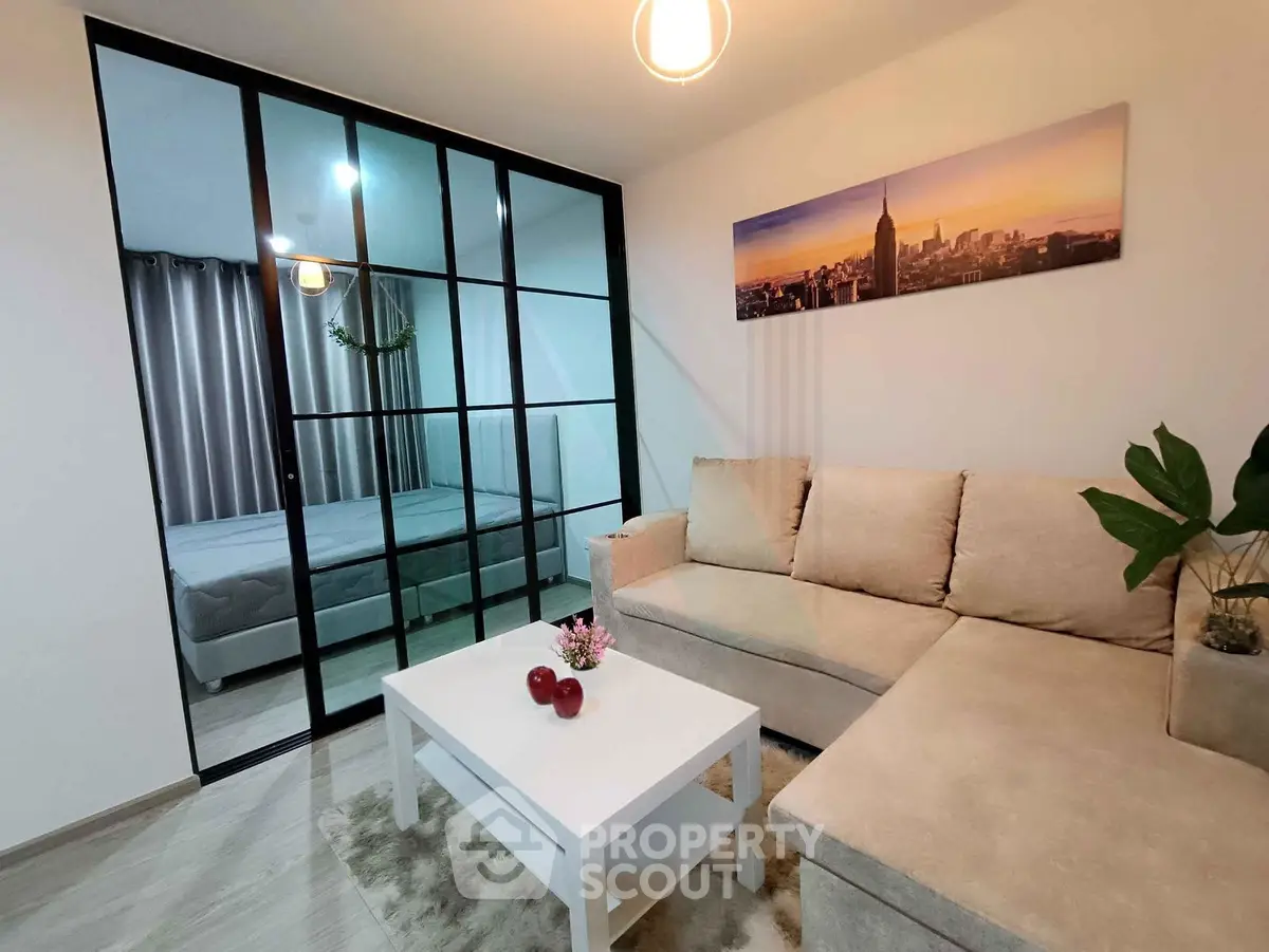 Modern living room with glass partition and cozy beige sofa in stylish apartment.
