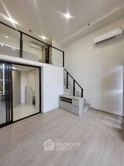 Modern duplex interior with sleek staircase and bright open space