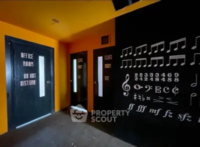 Unique music-themed office room with vibrant orange and black decor