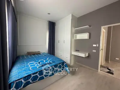 Modern bedroom with stylish decor and ample storage in a contemporary apartment.