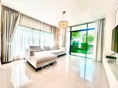 Spacious and bright living room with large windows and modern decor