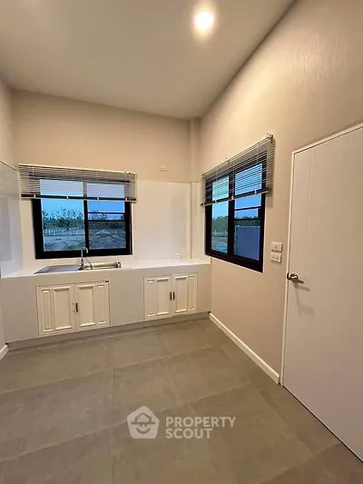 Spacious kitchen with modern design and large windows for natural light