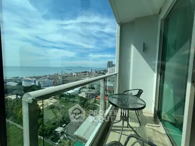 Stunning balcony view overlooking the ocean and city skyline, perfect for relaxation.