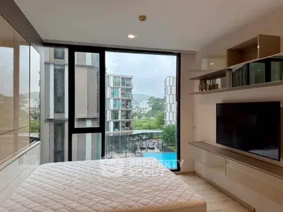Modern bedroom with large window and pool view in luxury apartment
