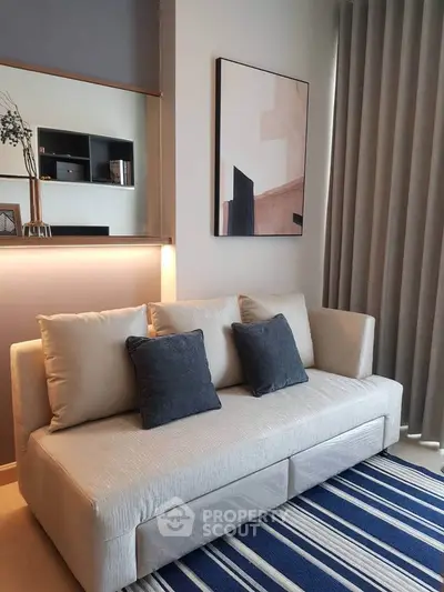 Modern living room with stylish sofa and abstract art, featuring elegant decor and cozy ambiance.