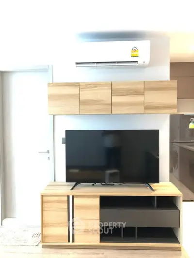 Modern living room with sleek wooden TV stand and wall-mounted air conditioner, showcasing contemporary interior design.