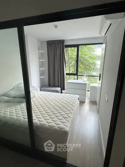 Modern bedroom with large window and stylish decor