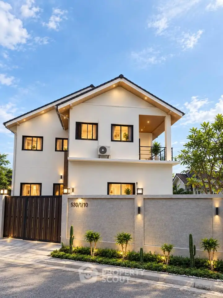 Modern two-story house with landscaped front yard and sleek exterior design.