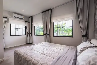 Bright and airy bedroom with large windows and modern decor