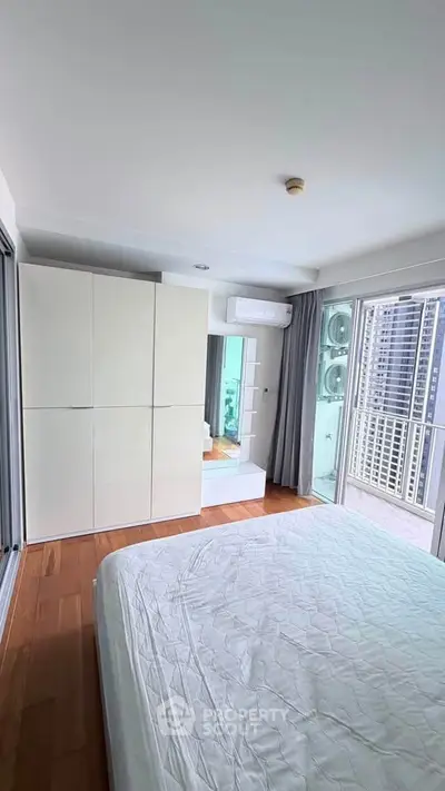 Modern bedroom with balcony view in high-rise apartment