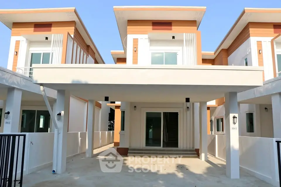 Modern townhouse exterior with clean lines and spacious driveway