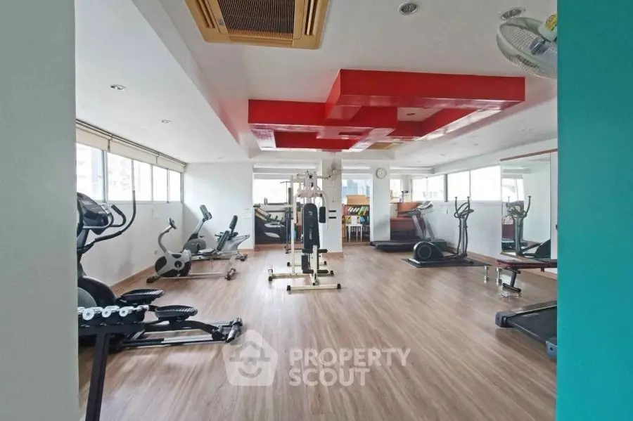 Spacious modern gym with state-of-the-art equipment and stylish design.