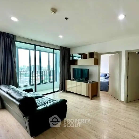 Modern living room with city view and sleek furnishings