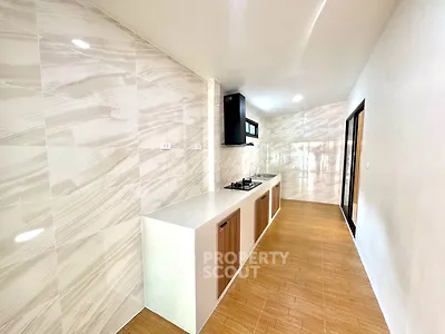 Modern kitchen with sleek countertops and gas stove in a stylish open layout