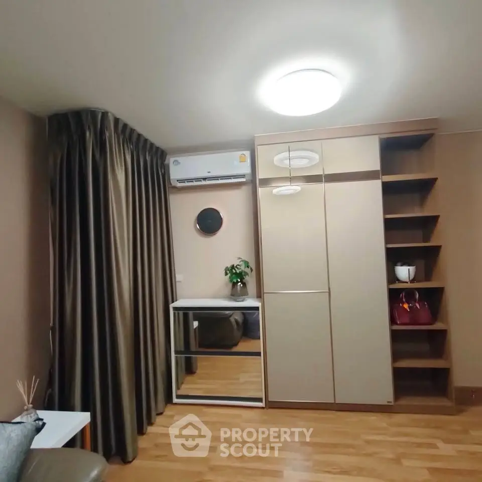 Modern bedroom with sleek wardrobe and air conditioning in stylish apartment