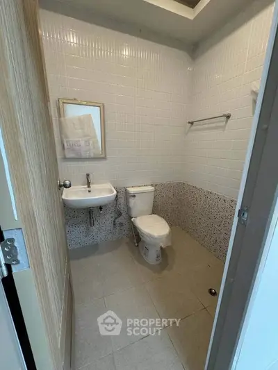 Modern bathroom with sleek fixtures and tiled walls in a contemporary apartment.