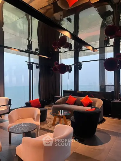 Luxurious modern living room with panoramic ocean views and stylish furniture.