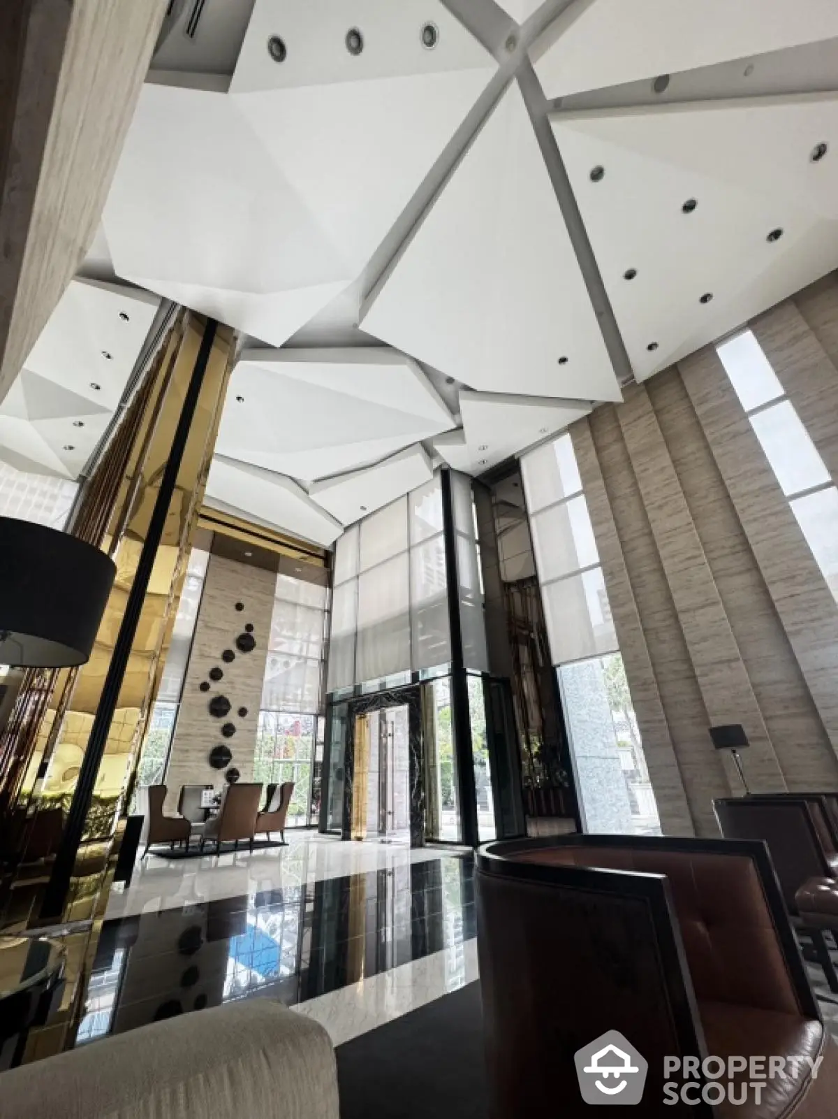 Luxurious modern building entrance with high ceilings and elegant decor