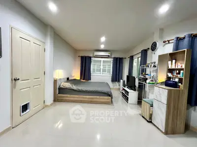 Spacious modern bedroom with sleek furnishings and ample natural light