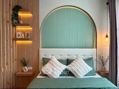 Stylish bedroom with modern decor and ambient lighting, featuring a unique arched headboard and cozy pillows.