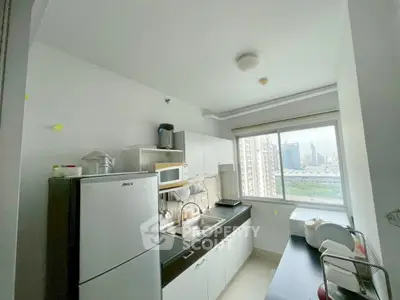 Modern kitchen with city view, featuring sleek appliances and ample natural light.