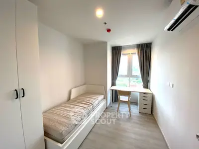 Bright and cozy bedroom with single bed and study desk near window.