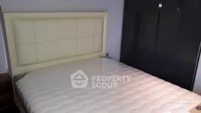 Modern bedroom with sleek wardrobe and plush headboard