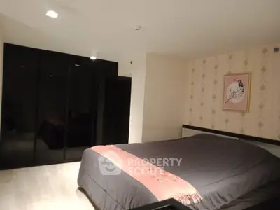 Cozy bedroom with modern black wardrobe and elegant decor