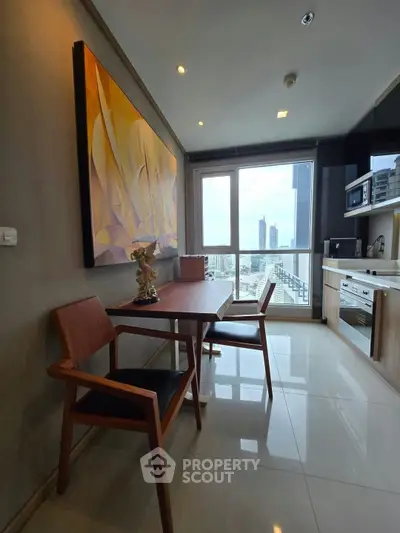 Modern kitchen with city view, sleek cabinetry, and elegant dining area in high-rise apartment.