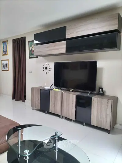 Modern living room with sleek TV unit and stylish glass coffee table