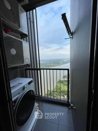 Stunning high-rise balcony with laundry appliances and breathtaking river view.