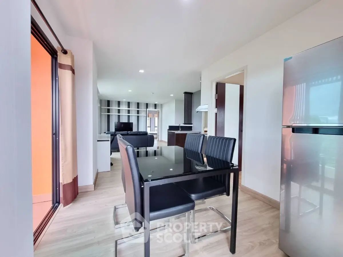 Modern open-plan living and dining area with sleek furniture and natural light.