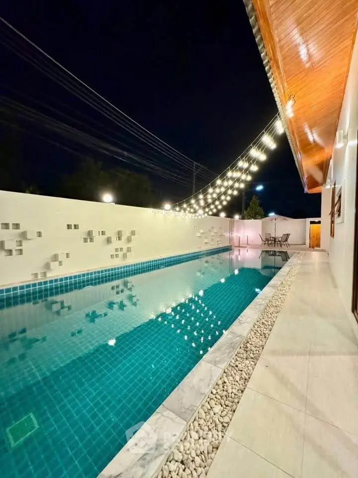 Luxurious night view of a modern swimming pool with elegant lighting and sleek design.