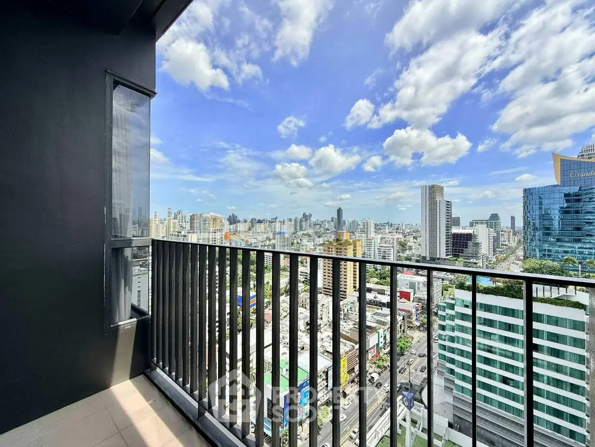 Stunning cityscape view from a high-rise balcony with modern railing and vibrant skyline.