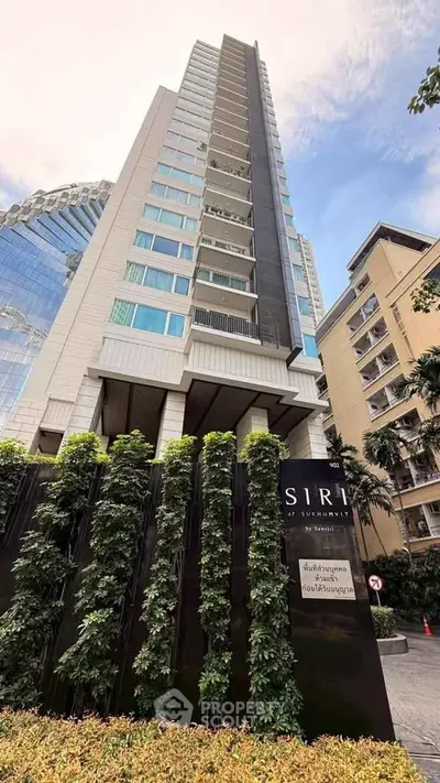 Stunning high-rise building exterior with lush greenery and modern architecture in prime urban location.