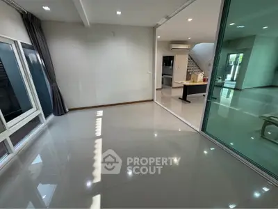 Spacious modern living area with large windows and sleek flooring