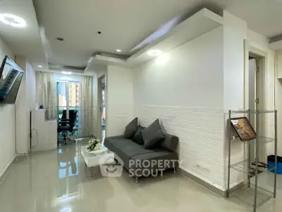 Modern living room with sleek design and city view, featuring a cozy sofa and stylish decor.