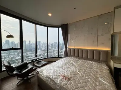 Luxurious bedroom with panoramic city view and elegant furnishings