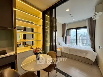 Modern studio apartment with open layout, featuring a cozy bedroom and stylish dining area with city view.
