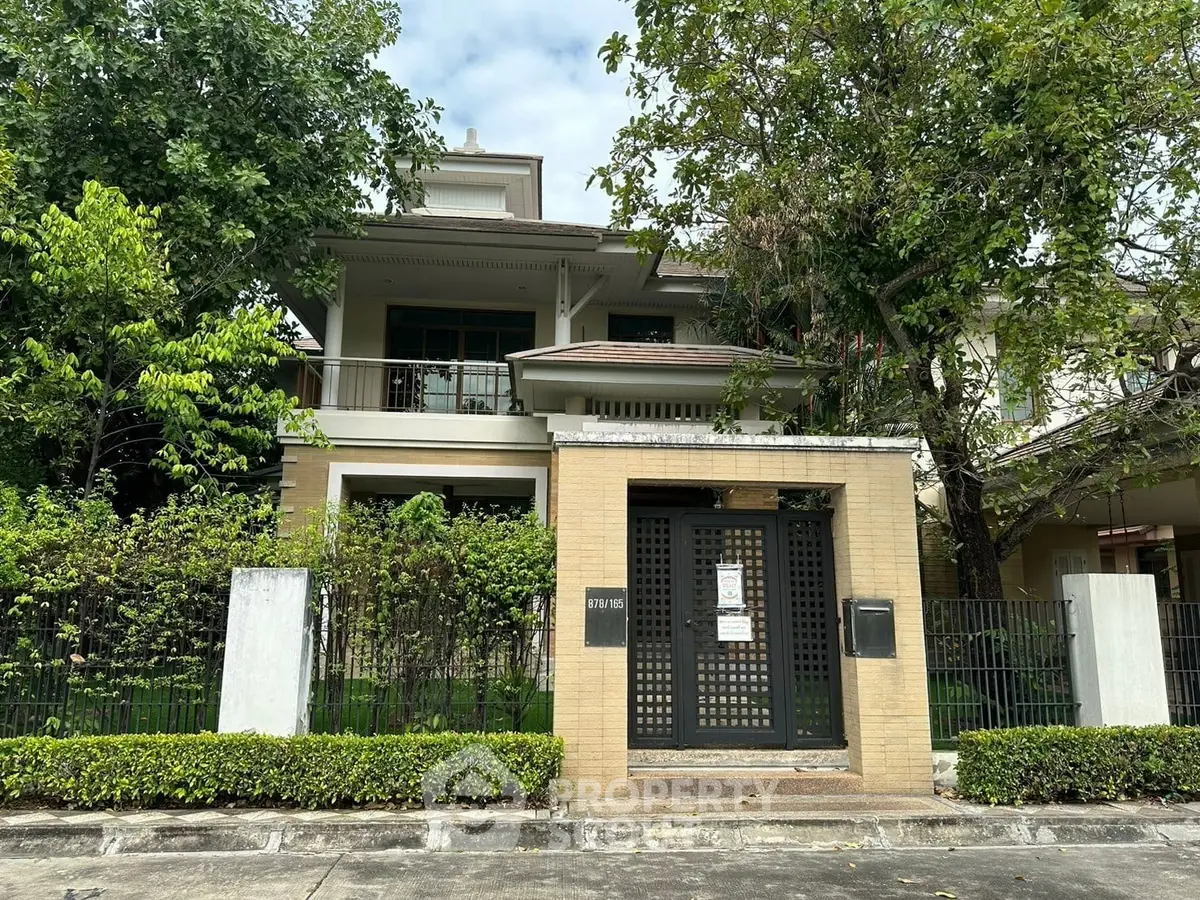 Charming two-story house with lush greenery and modern facade