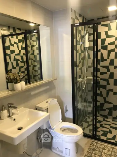 Modern bathroom with geometric tile shower and sleek fixtures