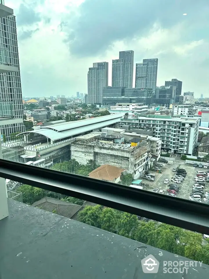 Stunning cityscape view from high-rise balcony with modern skyscrapers and urban landscape.