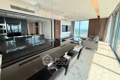Luxurious open-plan living room with stunning city views and elegant chandelier