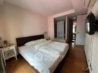 Cozy bedroom with wooden flooring and modern decor