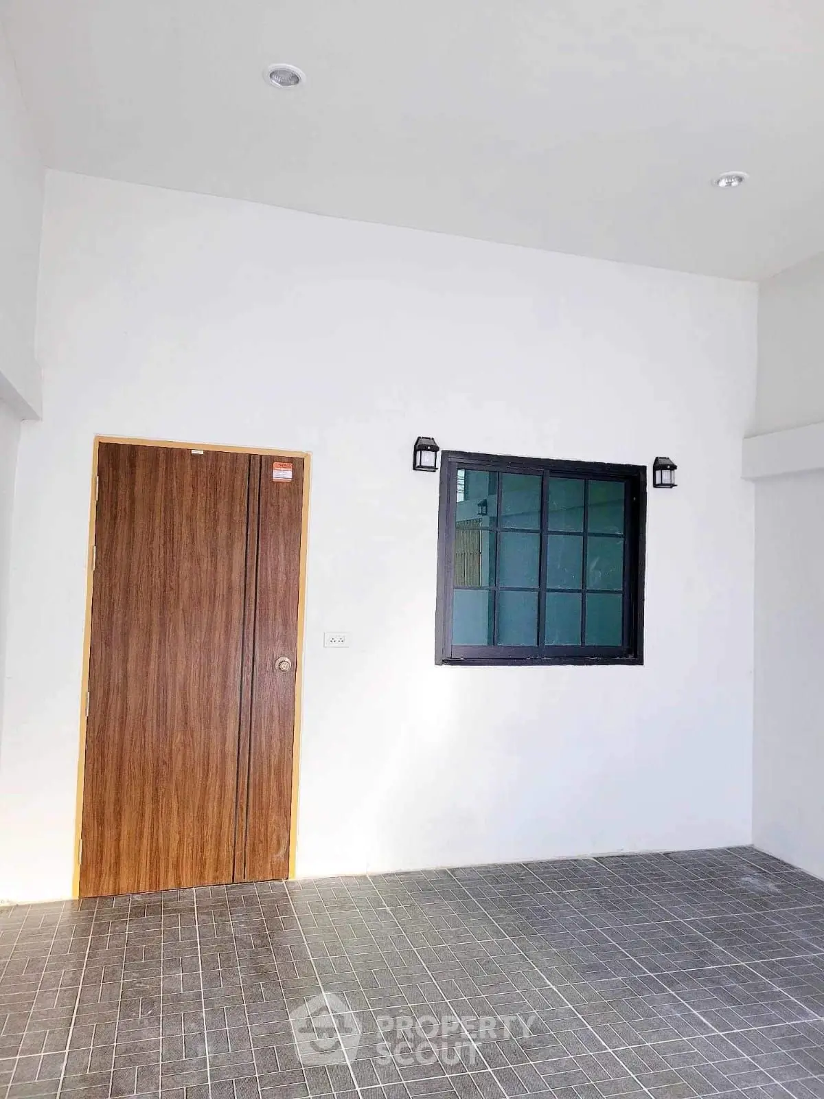Modern minimalist entrance with wooden door and window in a sleek tiled area