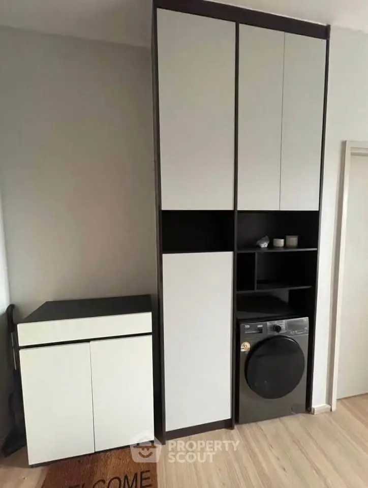 Modern laundry area with sleek storage cabinets and washing machine