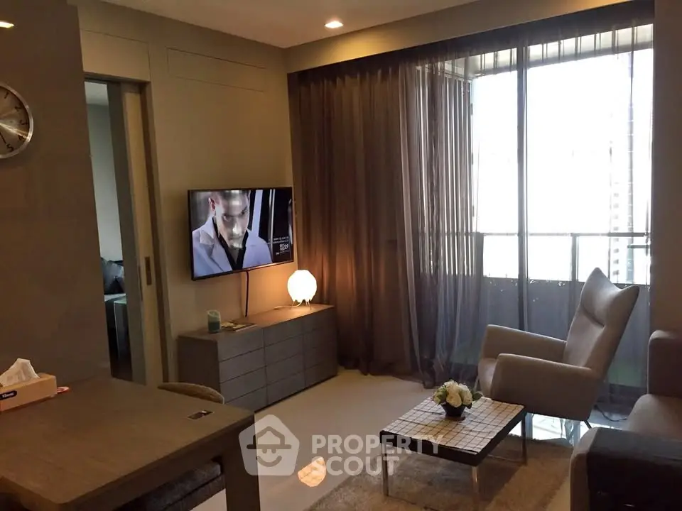 Modern living room with stylish furniture and large window for natural light