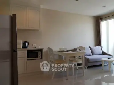 Cozy living room with modern kitchen and dining area in open layout apartment.